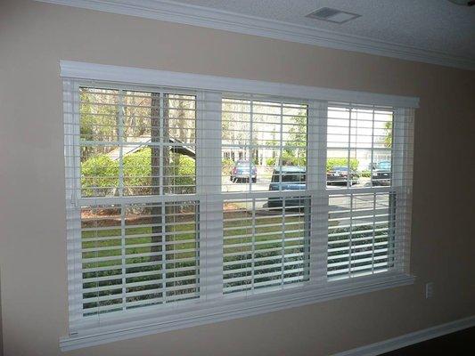 Fauxwood Blinds on a triple window with common valance