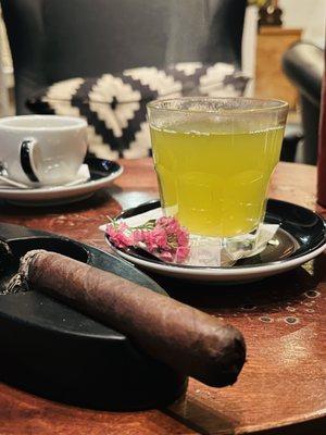 Green tea in glass cigar next to it