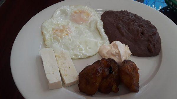 Central American Breakfast: Two fried eggs, refried beans, cream, fried sweet plantain, & cheese