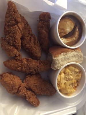 Chicken finger basket with mashed potatoes and gravy, mac-n-cheese, and a roll.