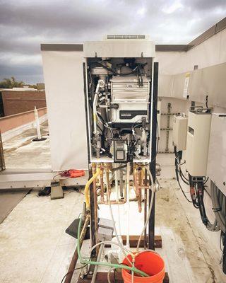 Performing Tankless Water Heater maintenance on this rooftop unit!