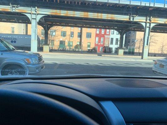 In my car parked , in between the two cars is the space to drive in from traffic .