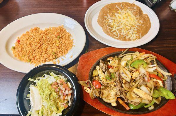 Mixed fajita (chicken & steak) with rice, beans and guacamole salad