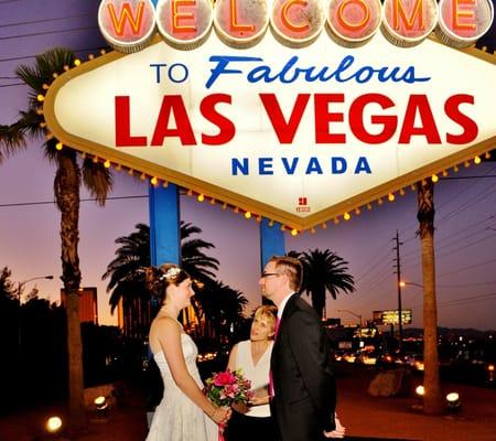 Rev. Nourish marrying a couple at the Las Vegas Sign.