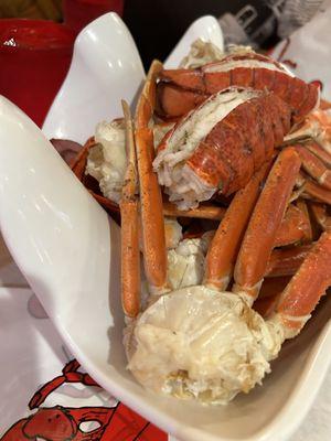 Seafood boil with sauce and seasoning on the side.