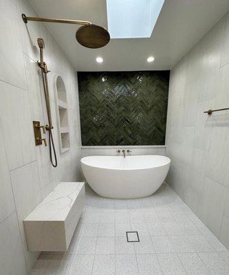 Beautiful free standing tub. Minimalist modern bathroom remodel with natural light bursting from a new skylight