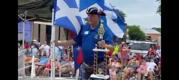 Capt Rick Briggs, SAMS Post 1298 member, on the organization's award winning float during the 104th July 4th Parade, Belton, TX, 2023.