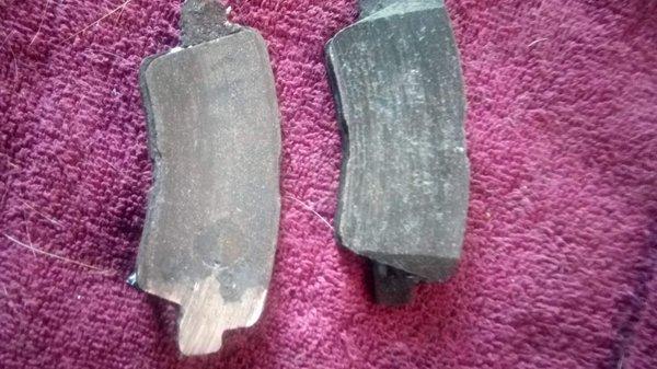 Brake pad worn down to exposed metal on metal. Contributed to premature rotor and pad failure - clearly.