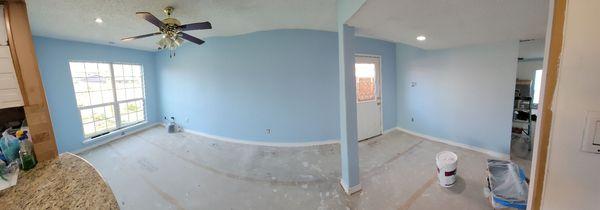 This is a panoramic of the dining room before the team cleaned up the ram board and painted the baseboards