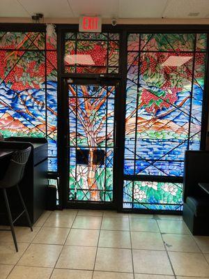 Coffee tree art glass adorns store front