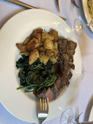 NY Strip Steak Lion with Roasted Potatoes and Red Wine Reduction Spinach