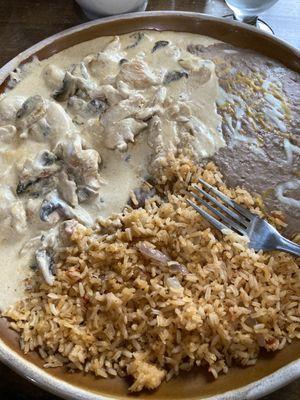 Pollo a la crema with mushrooms/refried beans/rice.