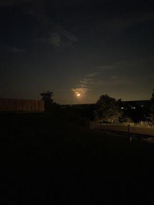 Harvest moon over a picnic table.