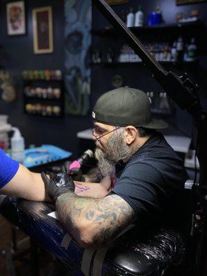 Artist Scott McClanahan working on a forearm tattoo