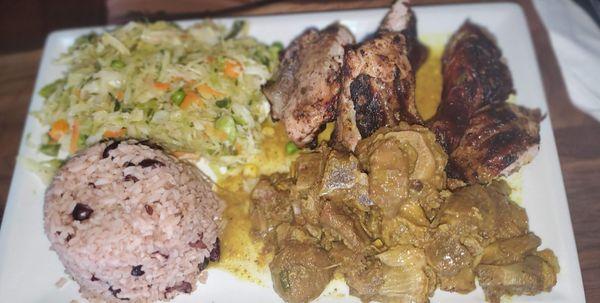 Create in your own plate with Jerk Chicken and Curry Goat with rice and beans and steamed vegetables