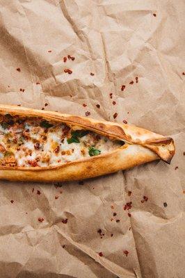 Hand cut diced beef pide with bell peppers, organic tomato, parsley, spices and mozzarella