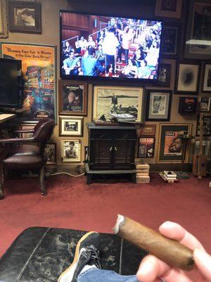 Cigar with a view of the television from a comfy barber chair