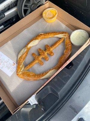 Football pretzel with cheese dip and jalapeño cheese dip.