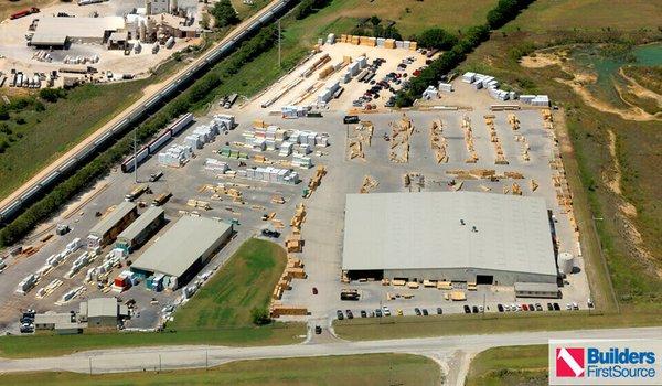 Building materials supplier Builders FirstSource's forklift is moving wood roof trusses.