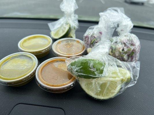 Salsa verde, salsa, limes, and cilantro & onion mix