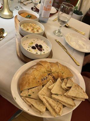 Mixed appetizers platter: eggplant spread, hummus, labneh. Uzbek bread and pita.