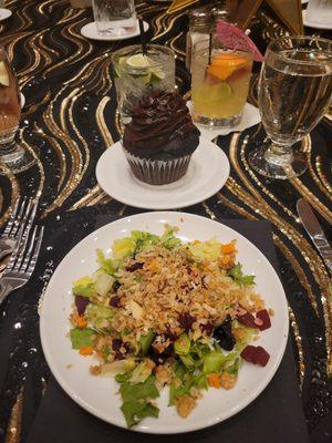 Harvest salad with spring greens, romaine, beets, roasted sweet potatoes and sprinkle of granola. Jumbo double chocolate cupcake in back