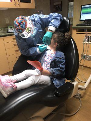 Having her teeth cleaned