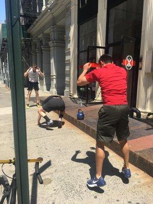 Hitting some burpees outside with a few clients.