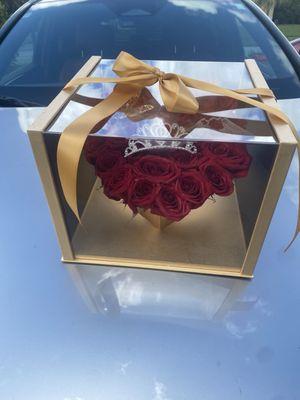 This a box heart shape full of red roses for a queen