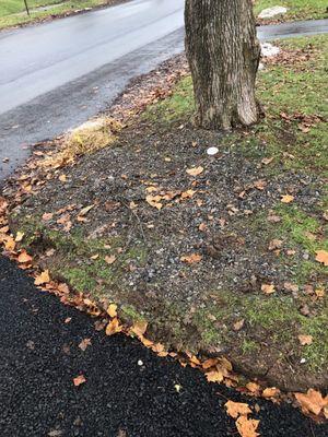 Piles of leftover gravel discarded into the lawn