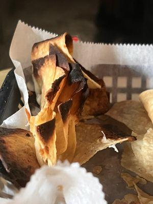 The burnt chips in the nachos