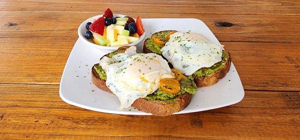 avocado toast with bagel seasoning, heirloom tomatoes, served on whole wheat with eggs of your choice