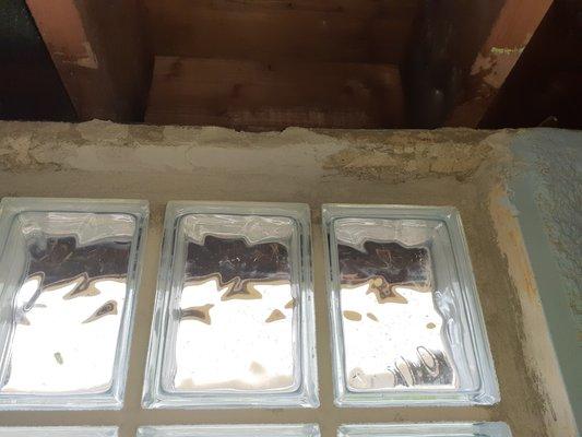 The three windows recently installed by Panel Window. All are surrounded by crumbling cement.