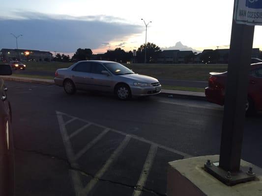 Employees parking on curb w/in little triangle parking lot, preventing cars from being able to pull around causing back up!