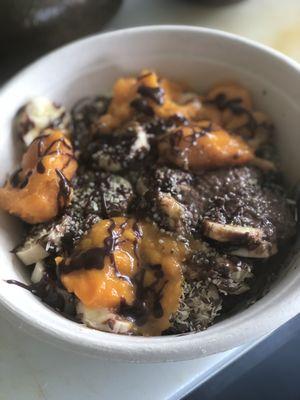 Coconut milk kauai chocolate chia seeds pudding bowl ....topped with fresh local mango , apple banana , hemp seeds , flax seeds and coconut