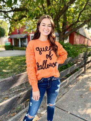 Be the Queen of Halloween in this sweater. There are mini pumpkins on the sleeves.