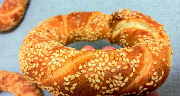 Simit is known as Turkish Bagel, a delicious Turkish street bread that is tangled sesame-bathed and ring-shaped like a bagel.