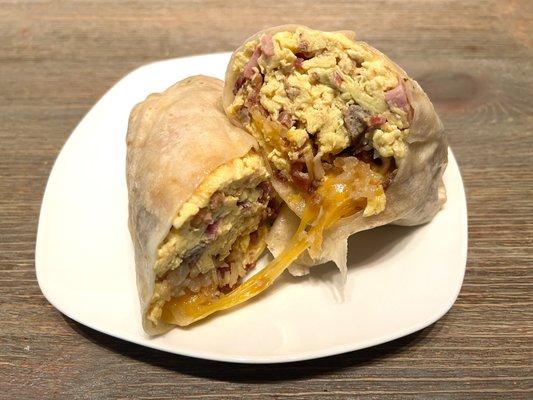 Signature Breakfast Burrito. Egg, cheese, bacon, sausage, ham, and hash browns. Comes with house made salsa.