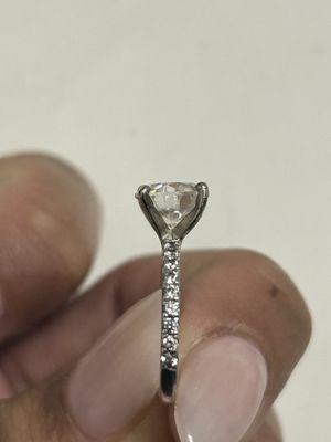 This picture it taken after going to them you can see the slight unevenness at the top. The moissanite it sitting up higher in the right.