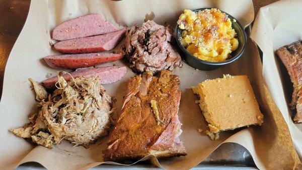 Baby back ribs and a three meat combo with pulled pork, moist brisket, classic sausage, mac and cheese, and cornbread