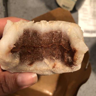 Inside of dessert dumpling. The filling was a chocolate flavored red bean paste.