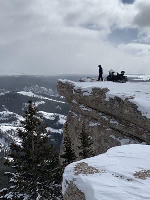 An adventurous snowmobiler taking in the view