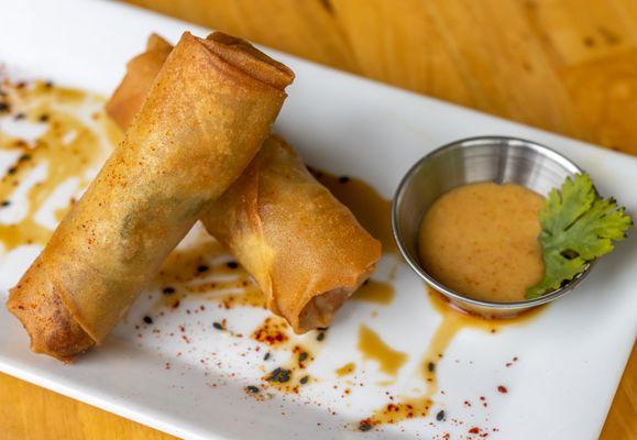 Craveable Egg Rolls! 2 per order: Braised beef, sweet onions & Napa cabbage in a crispy shell.  Spicy mustard for dipping!