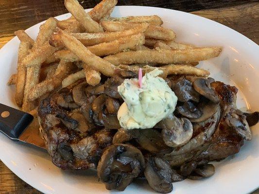 Ribeye topped with garlic butter and sautéed mushrooms served with ranch seasoned fries