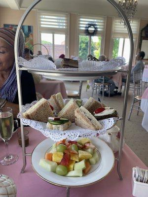 Royal tea option. Desert, finger, sandwiches, and fruit (from top to bottom)