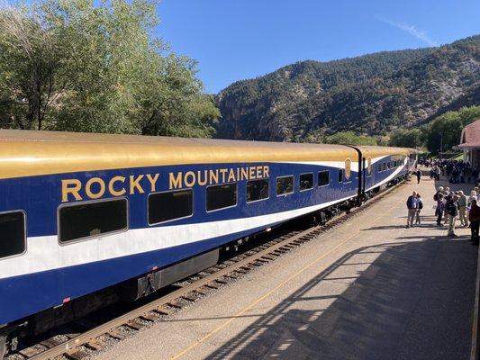 Rocky Mountaineer in the station.  That is a crew car in the foreground.