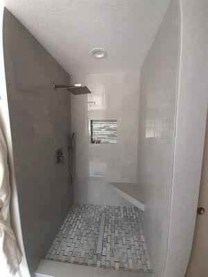 Master bathroom shower remodel in Diamond Bar, CA with niche and floating corner bench.