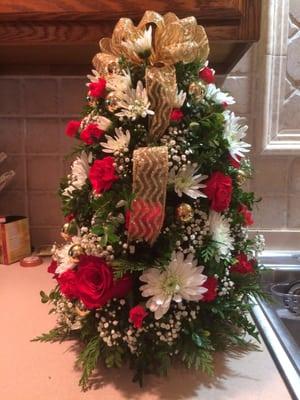 Beautiful Christmas tree shaped boxwood with roses, mums, baby's breath, gold xmas balls and gold ribbon.