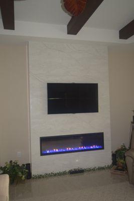 XLF60 Lenear Firebox with 55" TV above.  2 cm quartz stone floor to ceiling.