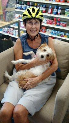 Sandra the cyclist, having a visit with Grace the Pharmacy Dog!